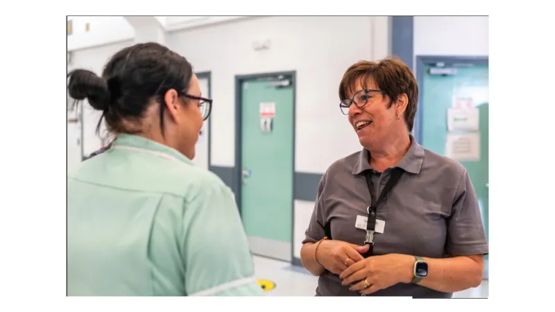 Clinical specialist reviewing documentation on a tablet